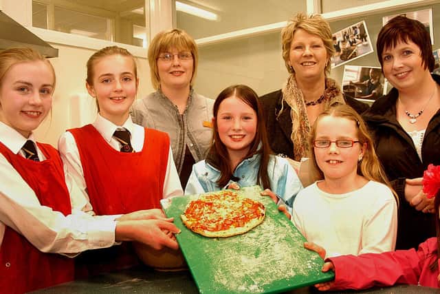 Ready for some pizza at Dunclug College open night were pipils Nicole and Louise with Home Economics teacher Mrs Hall and visitors Natasha, Eva, Jenna, Carolyn Gaston and Julie Park Gamble. INBT02-814H