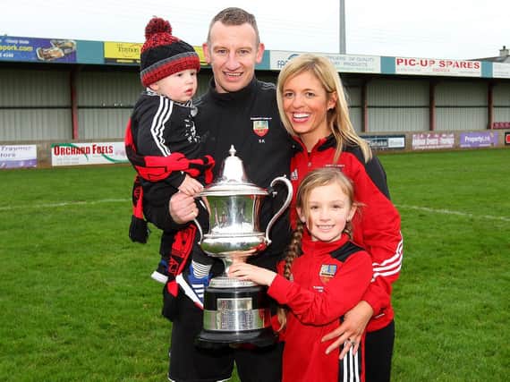 Banbridge Town manager Stuart King, who has a chance of winning £1 million celebrates winning the 2018 Bob Radcliffe Cup with his wife Bernice, son Charlie and daughter Lucy. Picture by Alan Weir/Pacemaker Press