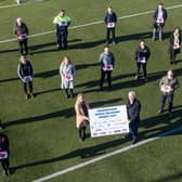 Pictured are representatives from the businesses who contributed to the Draperstown Digital Inclusion Fund 2021. Holding the sign is Mrs Georgina Grieve (Chief Executive of Workspace), Mr Laurence O’Kane (Chairman of Workspace).