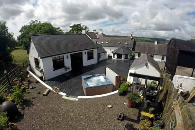 Features include an outside hot tub and landscaped raised feature garden area