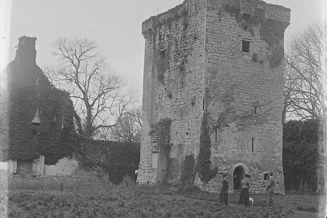 Two women, a man and a dog standing in front of the ruins of Shane's Castle near Randalstown, Co Antrim. NLI Ref: CLON1547. Picture: National Library of Ireland