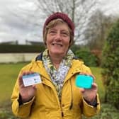Christian Aid supporter Rachel McCormick holds her coronavirus vaccination card and a bar of soap to signify that soap and water remain among the few defences against infection for people in low-income countries until vaccines are made widely available