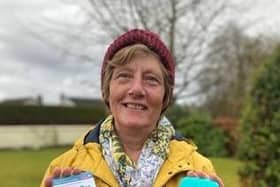 Christian Aid supporter Rachel McCormick holds her coronavirus vaccination card and a bar of soap to signify that soap and water remain among the few defences against infection for people in low-income countries until vaccines are made widely available