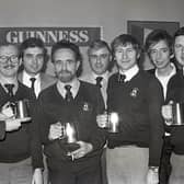 Mr John Kinahan, left, marketing manager, Arthur Guinness (Belfast) handing over trophies to the Holywood Yacht Club team which won the Guiness Inter-Pub/Club Charity Quiz, run in association with the Holywood Round Table. The team beat the Holywood Social Club in the district final. In the picture are Norman Bennett, captain, Austin Treacy, Tom Smeltzer and John Bingham. Also included are John Galbraith, scorer, Roy Williams, questionmaster, and Geoff Hunt, timekeeper. Picture: News Letter archives