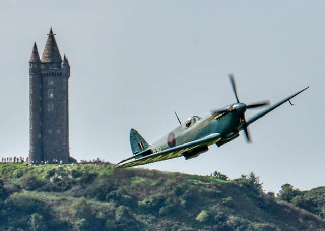 A Spitfire flies close to Scrabo Tower in Newtownards in September 2020. Picture: Simon Graham