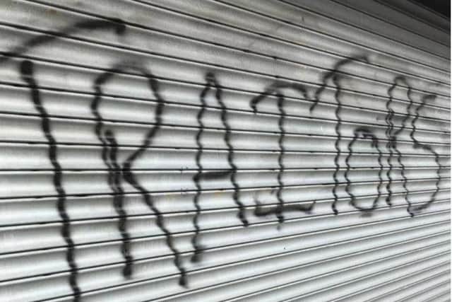 Graffiti on the shutters of the DUP's Larne Main Street premises.