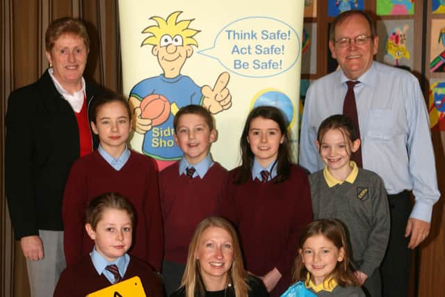 Julie Carson (NIE safety officer), pictured with pupils from St. Louis and St. Mary's Primary Schools, where she gave a talk on electricity safety. Included are Gabrielle Kelly and Liam Corey. BT49-223AC