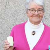Christian Aid supporter Nora Gibson with a bar of soap and her vaccine card.