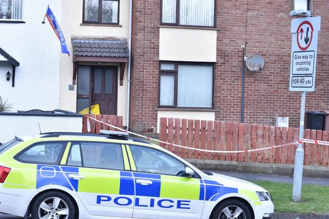 Police at the scene in Derrycoole Way on Saturday. A woman's body had been found at the property on Friday night. Picture: Colm Lenaghan/Pacemaker