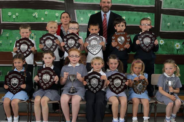 P1,2 and 3 pupils who received their awards at the Harryville Primary School prizeday are seen here with guests of honour Tim Wilson, Chief Executive of Netcom (who was team leader of the Business in the Community Challenge) and Patton's Training Co-ordinator Lisa Blair. BT26-107JC