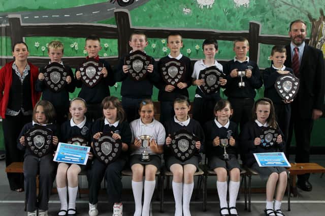 P4,5 and 6 pupils who received their awards at the Harryville Primary School prizeday are seen here with guests of honour Tim Wilson, Chief Executive of Netcom (who was team leader of the Business in the Community Challenge) and Patton's Training Co-ordinator Lisa Blair. BT26-108JC