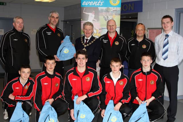 Management and playing members of Carniny Youth FC Under 14 and Under 15 teams who travelled to Preston to take part in their Easter Cup tournament, received Ballymena Borough Council kit-bags from the Mayor of Ballymena Cllr Maurice Mills. Back L-R, Davison and Robin Park (U15 managers), Cllr Mills, Stephen Barr and Stephen Armstrong (Under 14 managers), David Lamont (Ballymena Borough Council Sports Development Officer). Front, L-R, Clinton Armstong, Samuel McIlveen, Simon Boyd, Zak Barr and Joe Scullion. BT15-170CS