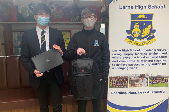 Pupils Adam Ferrante and Robbie Currell receiving the laptops on behalf of Larne High School.