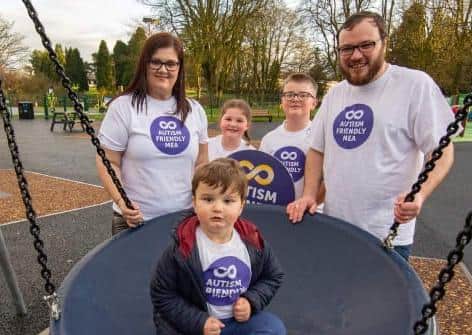 Caleb Armstrong tries out one of the new swings at the refurbished People's Park play area in Ballymena. Also pictured are his dad, Cllr Matthew Armstrong (who sits on Council's Autism Steering Group), mum Nicola, brother Ollie and sister Macie.