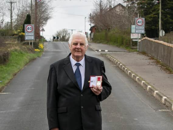 Cookstown 100 race secretary Norman Crooks with his British Empire Medal on the Cookstown 100 course in Co Tyrone. Picture: Baylon McCaughey.