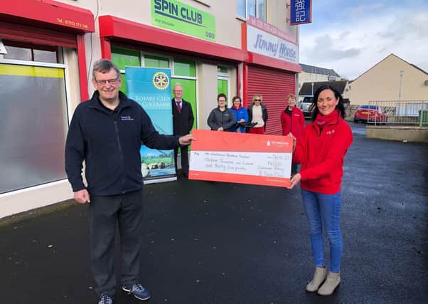 Graeme Strachan, President of the Rotary Club of Coleraine presenting Kerry Anderson from Air Ambulance NI with a cheque for £13,135, keeping the air ambulance flying for over two days