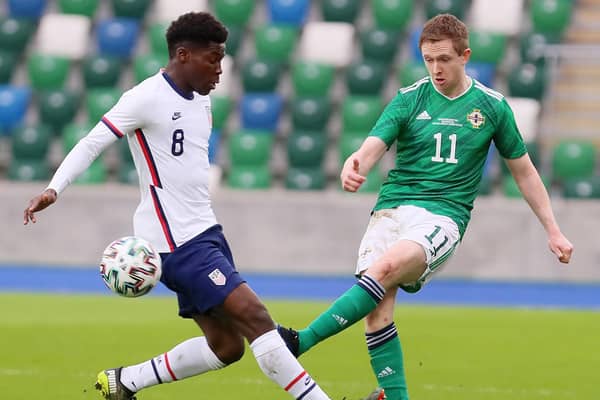Northern Ireland's Shane Ferguson gets his pass away before USA winger Yunus Musah could challenge. Picture courtesy Jonathan Porter/PressEye