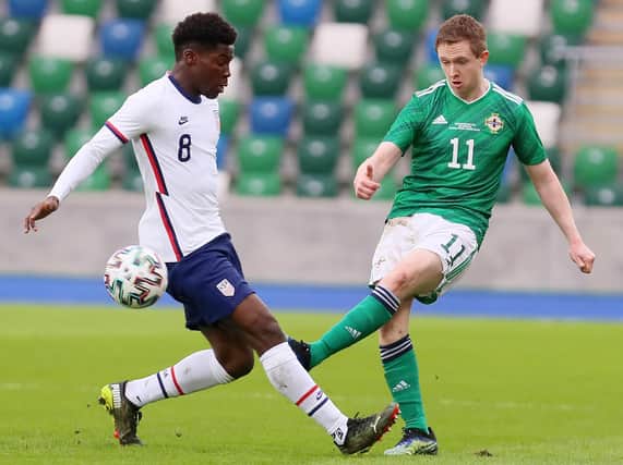 Northern Ireland's Shane Ferguson gets his pass away before USA winger Yunus Musah could challenge. Picture courtesy Jonathan Porter/PressEye