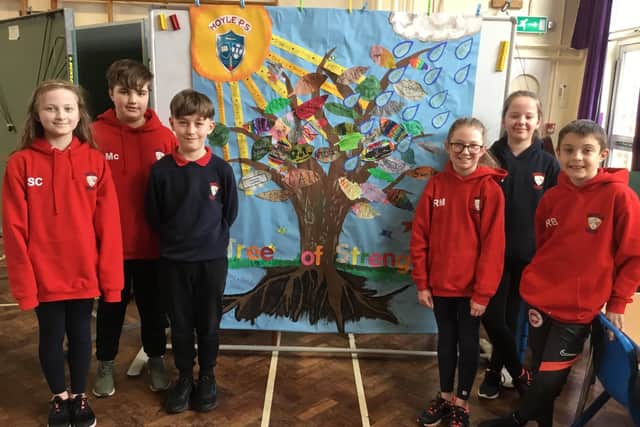 Children from Moyle Primary School proudly display their Tree of Strength.