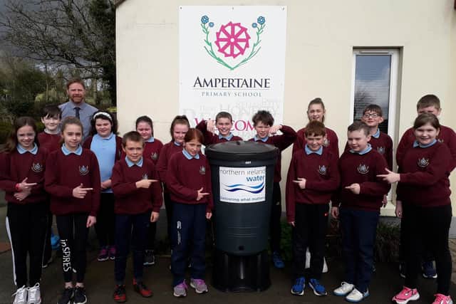 Pictured are pupils with their new waterbutt and principal Michael Dillon.