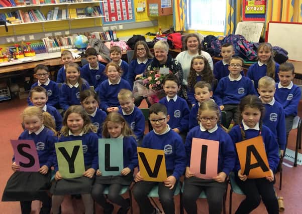 Pupils of Carnalbanagh Primary with Sylvia Millar who worked at the school for over 16 years