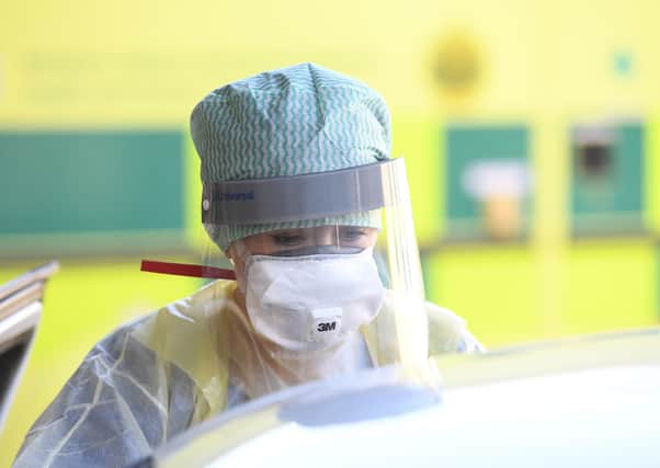 An Emergency Department Nurse during a demonstration of a Coronavirus pod and COVID-19 virus testing procedures.