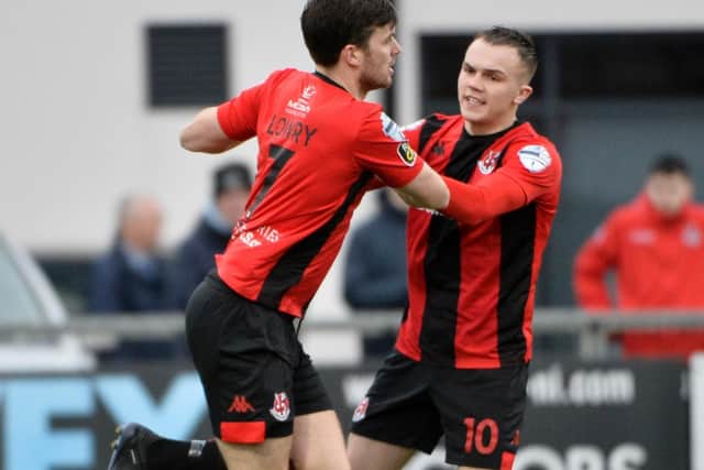 Crusaders' Philip Lowry celebrates with team-mate Rory Hale, after he fired home their equaliser against Institute.
