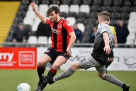 Crusaders midfielder Philip Lowry gets away from Institute's Brendan McLaughlin.