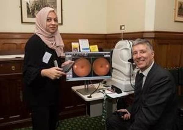Fatma Jagani (Vision Express) with Paul Girvan MP and the OCT machine.