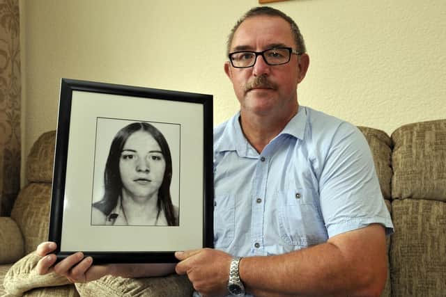 Gerard Beattie with a photograph of his late sister, Marian. INPT32-100gc