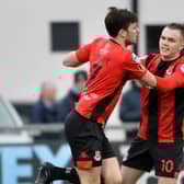 Crusaders Philip Lowry celebrates with Rory Hale after scoring against Institute.