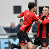Crusaders Philip Lowry celebrates with Rory Hale after scoring against Institute.
