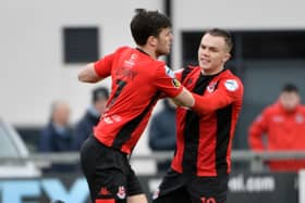 Crusaders Philip Lowry celebrates with Rory Hale after scoring against Institute.