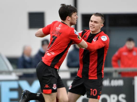 Crusaders Philip Lowry celebrates with Rory Hale after scoring against Institute.