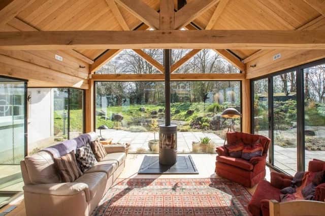 the listed thatched cottage is connected to its complementary oak and glass sunroom by two glazed links around a central courtyard