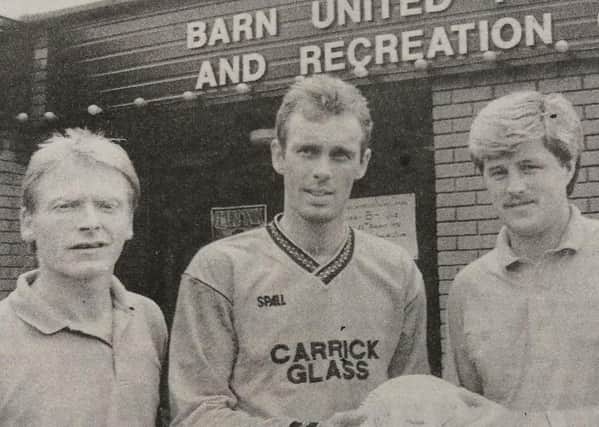 Colin Farr, assistant professional golfer at Carrick Golf Club, presents a match ball to Barn United player, Paul Machie, as Trevor Gault (manager) and Billy Manderson (chair) look on .
1992