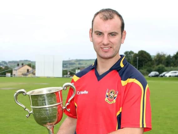 Brigade skipper Andy Britton, with the Long's Supervalu Premier Division trophy, which they won last season.
