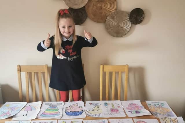 Poppy Ashton with some of her paintings