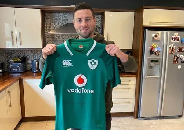 International rugby player John Cooney has signed and donated a coveted Ireland rugby jersey to support Cancer Focus Northern Ireland.