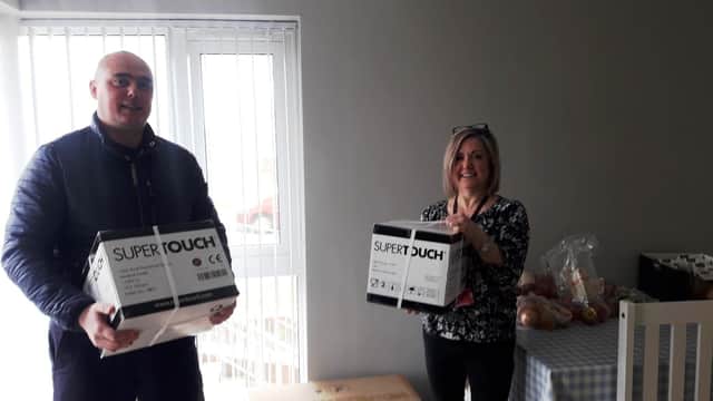 Pictured receiving the delivery of the gloves is Liz Warwick, Acting Team Leader at Trostan Avenue Hostel from Alan Barr, Freemason from the Seven Towers and Masserene District charity Committee.