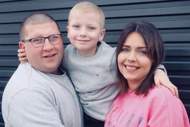 David Watson with son Adam (who has battled cancer) and wife Sara.