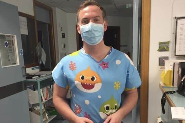 A medic, wearing one of Valerie Kelly's gowns says: "Came on shift and found some nice baby shark scrubs had been left for me. Brightened up my day. Thank you."