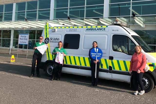 Valerie Kelly with members of the St John's Ambulance Service who arrived at Tesco in Portadown to take delivery of scrubs made by the Tandragee woman