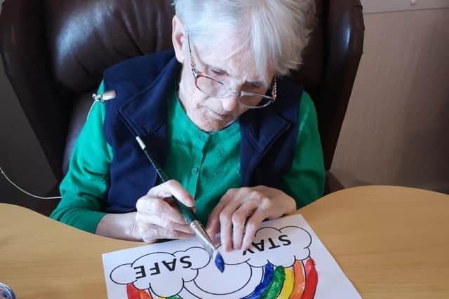 Mary paints a rainbow to send to her family.