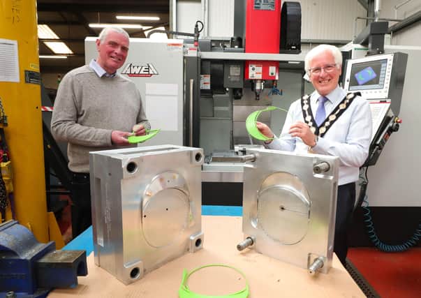 Mayor, Councillor Alan Givan is shown firsthand by Roger Vance, Managing Director, the face visor components being produced by Ad-Vance Engineering