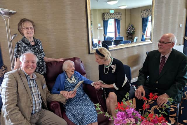 Ethel Barbour is presented with a special birthday message from Queen Elizabeth by Lord Liutenant of County Londonderry Mrs Alison Millar, surrounded by her children Robert, Miriam and David