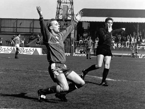 Stevie Cowan, in possibly the most iconic image within Portadown club history, is captured dropping to his knees in celebration at the final whistle of the Irish Cup victory over Glenavon in 1991. Cowan's brace secured a landmark league-and-cup trophy double for the Ports.
