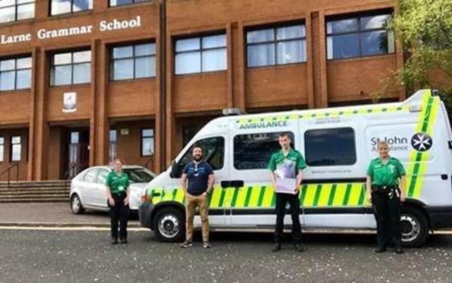 St John Ambulance collecting head visors from Mr McCoy at the school.