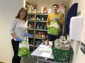 Foodbank volunteers pack bags of supplies.