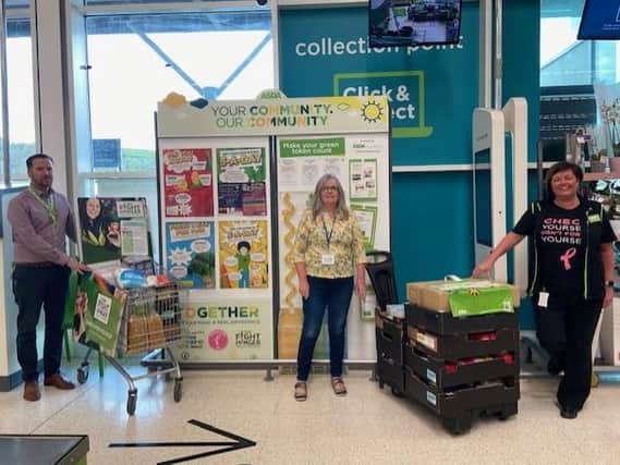 Asda Larne General Store Manager, William Brown and Community Champion, Catherine McCallion hand over the donation to Catherine Lynas from Larne Foodbank.